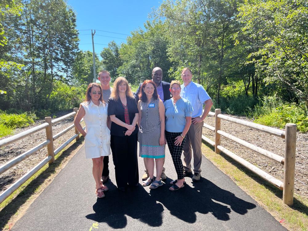 A group of people standing on the new part of Eastern Trail in South Portland, Maine.